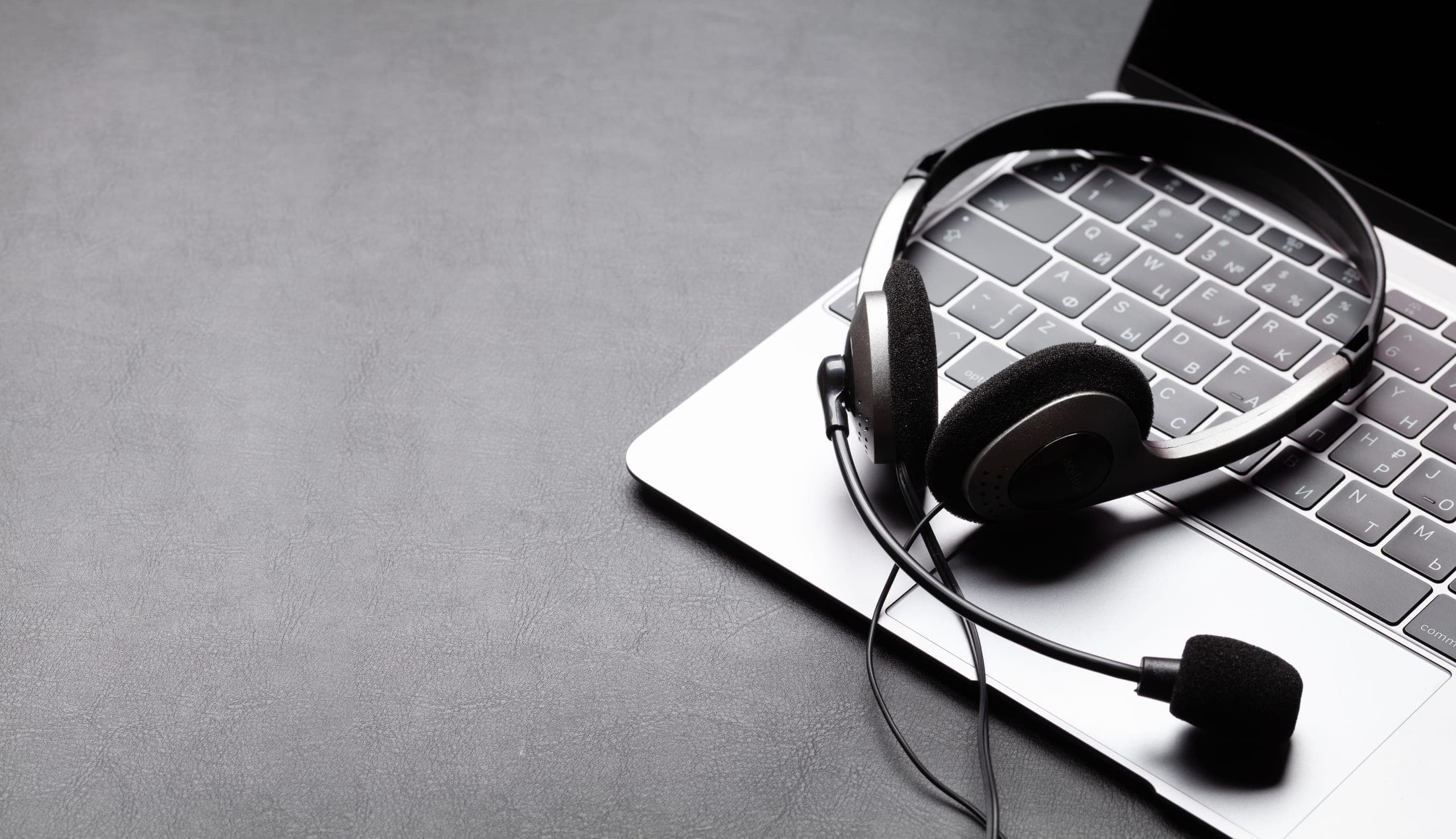 Headset resting on a laptop keyboard